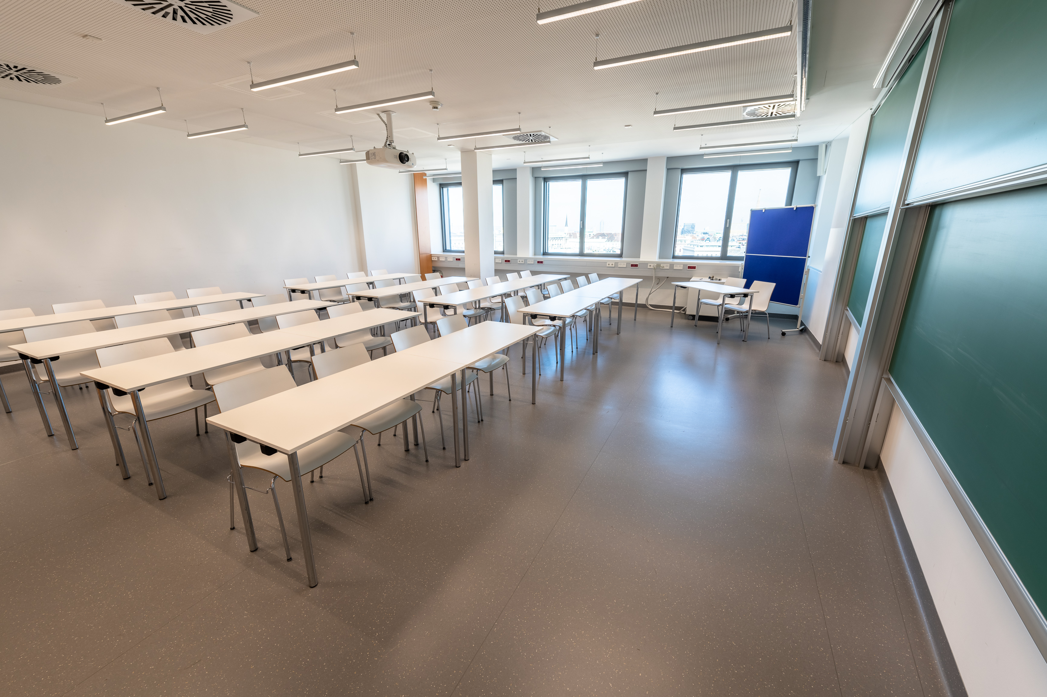 Seminar Room BA 10A set up with rows of tables, projector and chalkboard